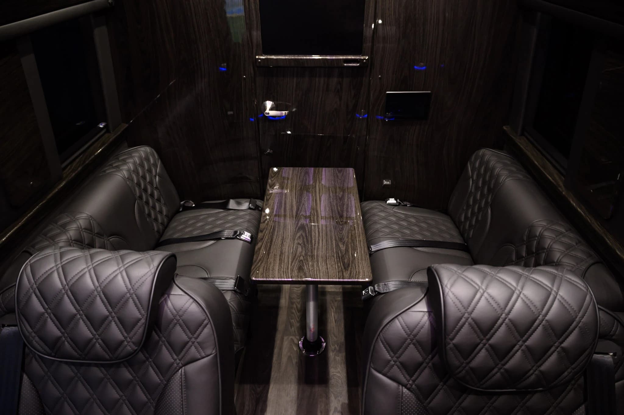 Travel in comfort with quilted leather seating, a built-in conference table, and a private cabin layout designed for business travel, Napa tours, airport transfers, and group transportation across the Bay Area.